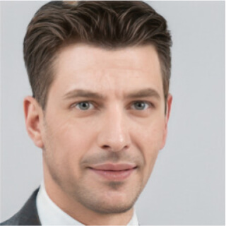 Professional headshot of a man with styled hair and a slight smile.