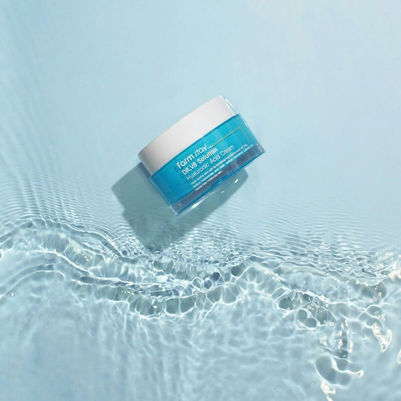 A skincare product jar floating on clear, rippling water with a blue background.