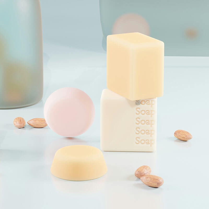 Various shaped soap bars and almonds on a light surface.