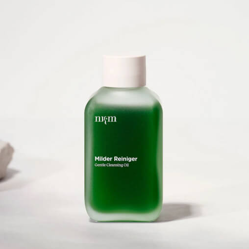 Green bottle of gentle cleansing oil labeled 'Milder Reiniger'.