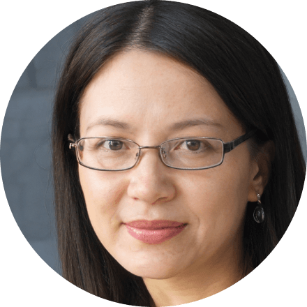 Close-up portrait of a woman with glasses and earrings.