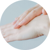 Person applying lotion to the back of their hand.
