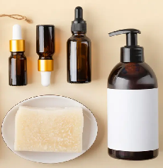 A collection of amber cosmetic bottles and a soap bar on a beige background.