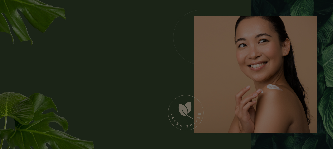 Smiling woman applying cream to shoulder